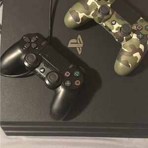 Sony Console with Black and Camouflage Controllers